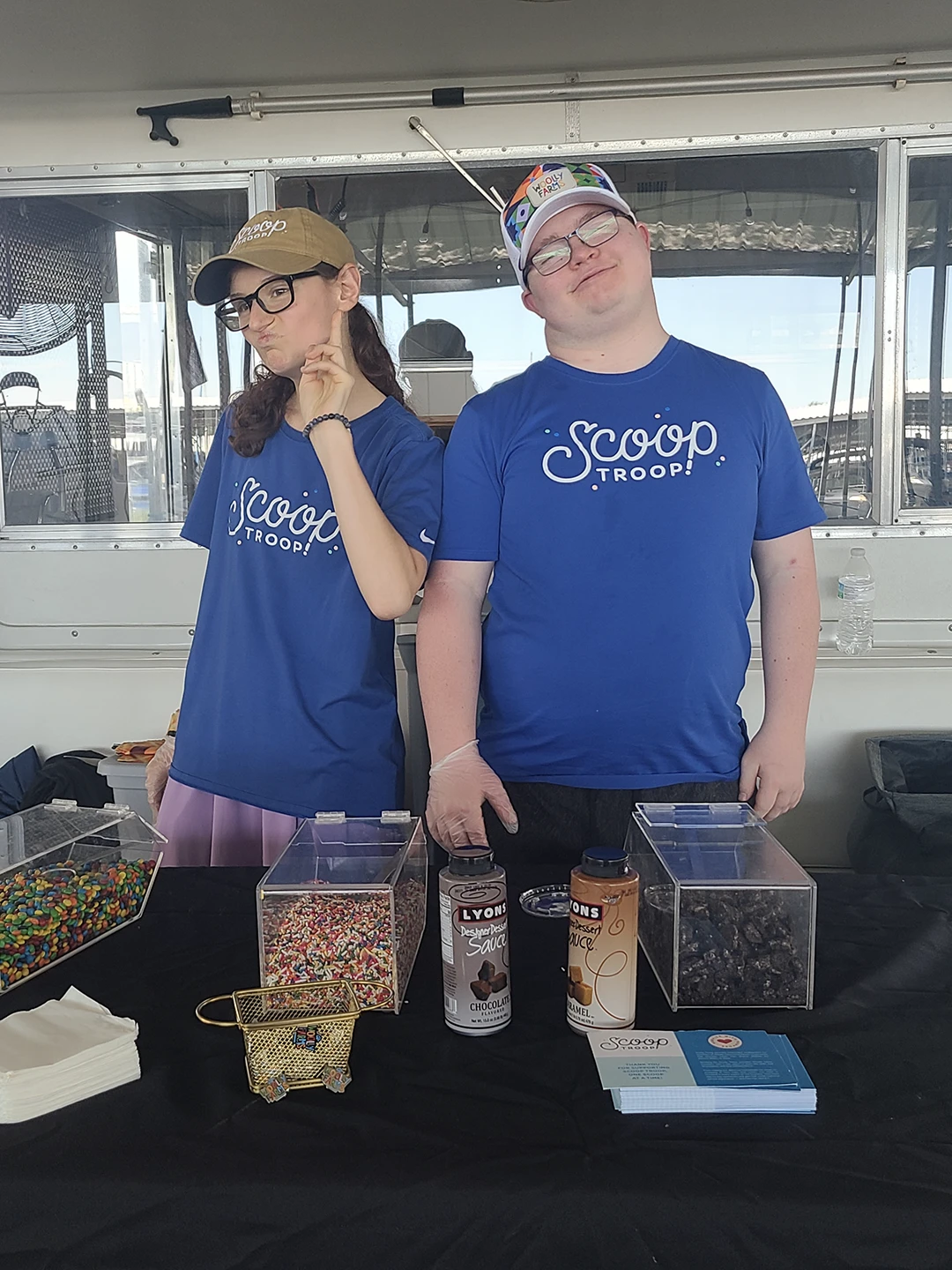 two scoop troop employees posing for the camera