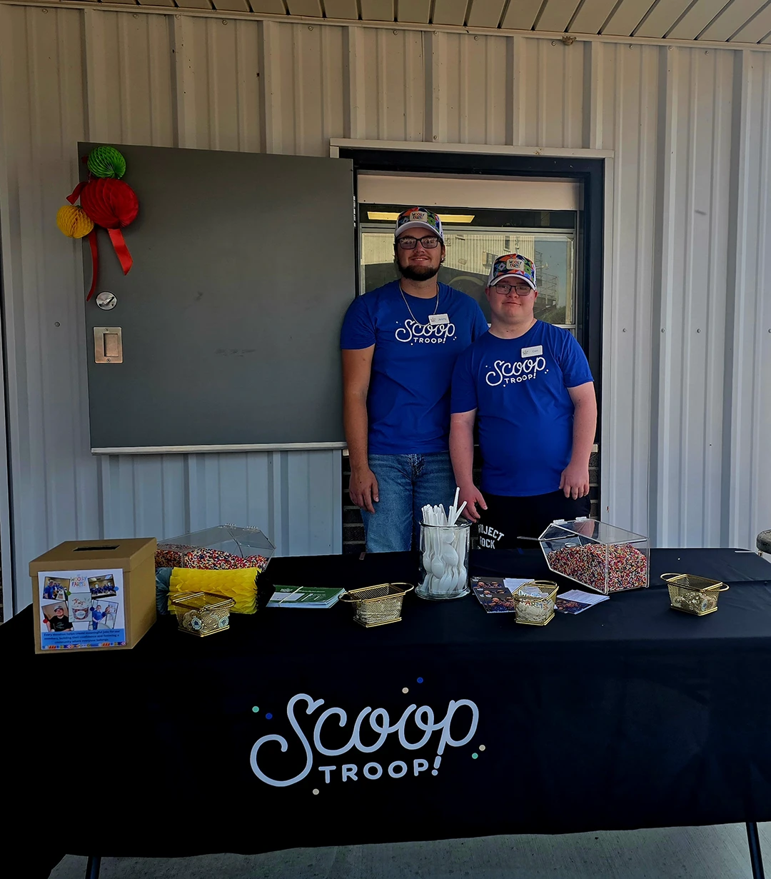 two scoop troop employees posing for the camera